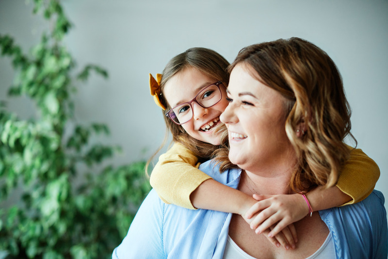 Patient smiling with their child after teeth whitening